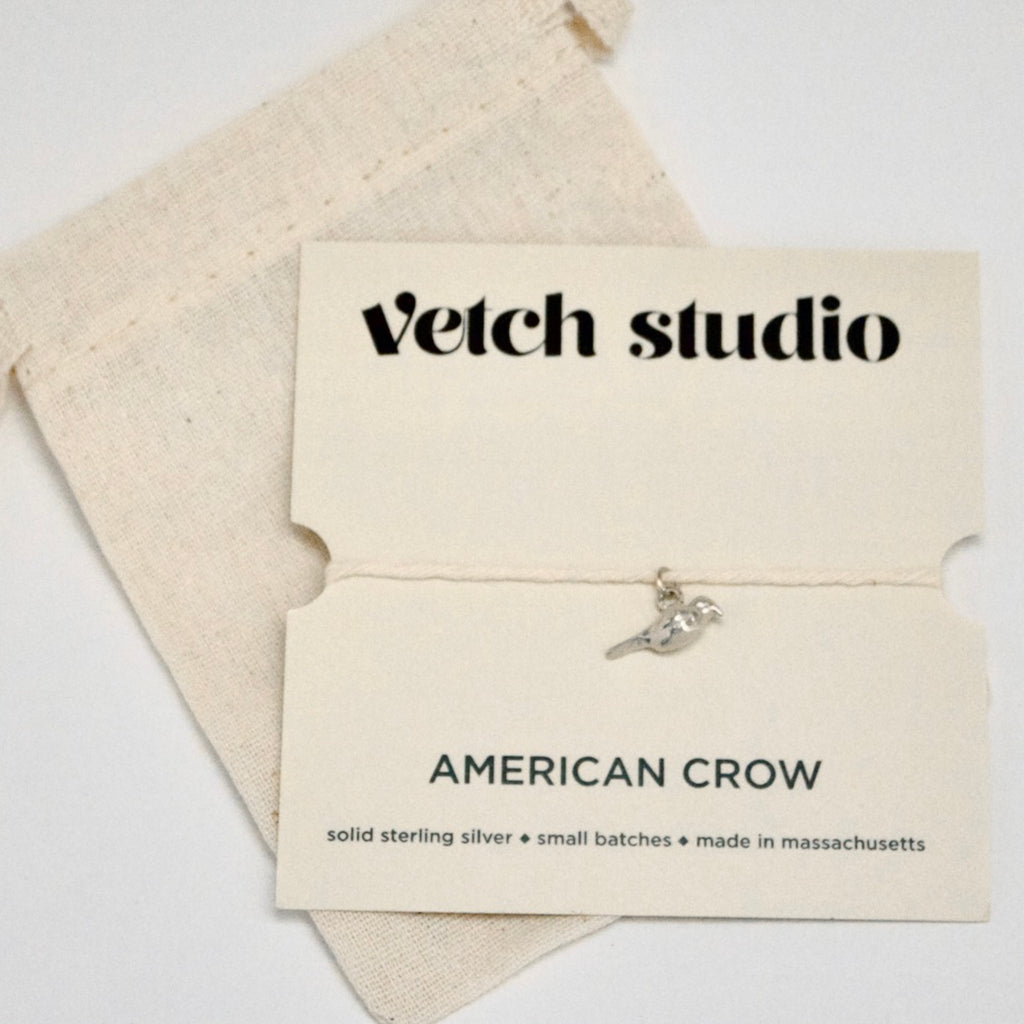 Jewelry card with 'Vetch Studio' branding and an American Crow charm on a white background.