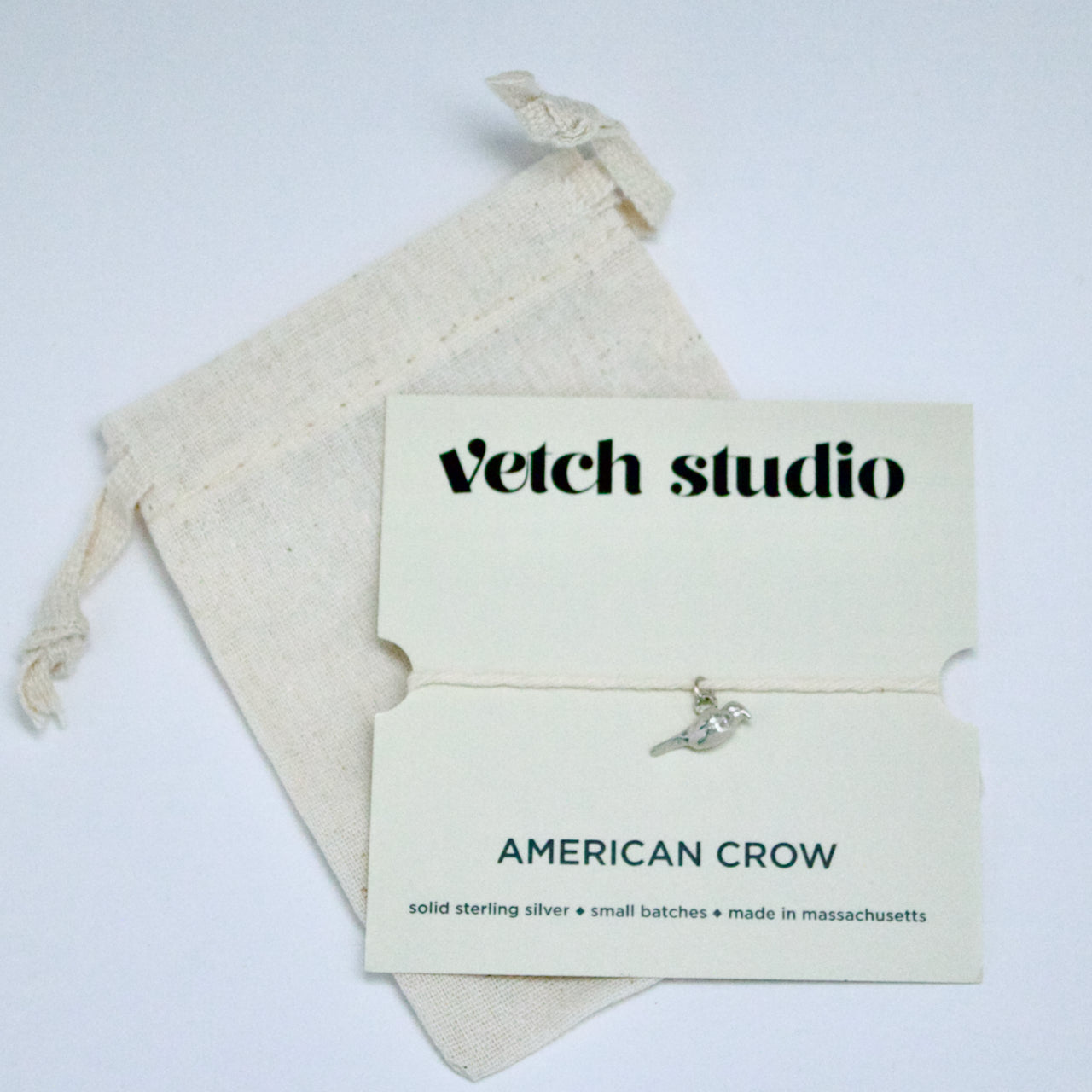 Jewelry card with 'Vetch Studio' branding and an American Crow charm on a white background.