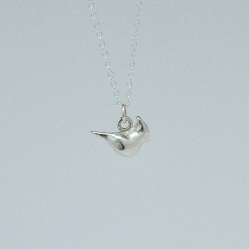 product image of a sterling silver cardinal charm on a chain necklace facing right