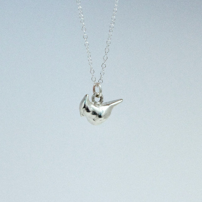 sterling silver cardinal charm on a chain facing left