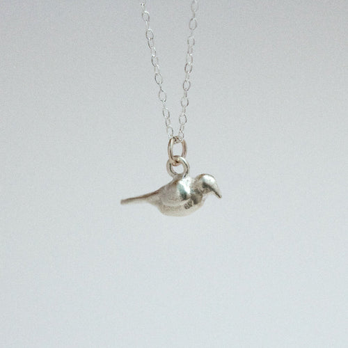sterling silver crow charm on a chain facing right