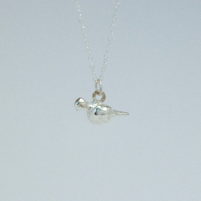 product image of a sterling silver mourning dove charm on a chain necklace facing left