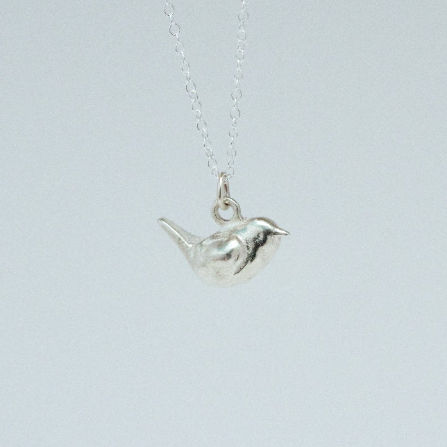 product image of a sterling silver wren charm on a chain necklace facing right