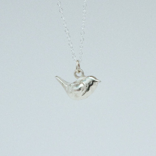 product image of a sterling silver wren charm on a chain necklace facing right