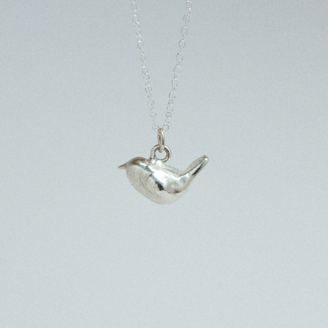 sterling silver wren charm on a chain facing left