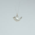 sterling silver wren charm on a chain facing left
