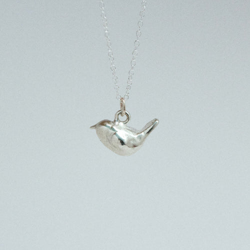 sterling silver wren charm on a chain facing left